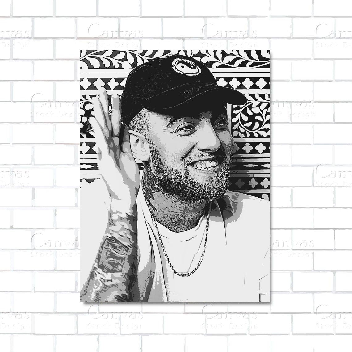 Black and white portrait of a person with tattoos and a cap on a decorative frame against a white brick wall.